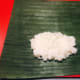 Place two tablespoons of steamed rice over the banana leaf.
