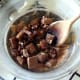 Chocolate is gently stirred as it melts
