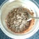 Bran flakes are added to the bowl in stages