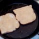 Egg soaked bread is put on to fry