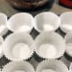 Line the baking papers in the muffin tin.