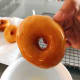 Dip the donut into the sugar glaze mixture.