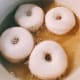 Frying the donuts.