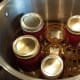 I loaded them into my water bath canner and covered them with water by a few inches.