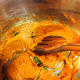 Add the curry powder. Keep stirring for a few minutes until the oil surfaces on top of the paste.