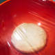 Transfer the dough into a greased bowl and cover with cling wrap.