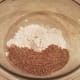 Start by adding half of your flour and your flaxseed to a large mixing bowl.