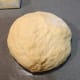 Transfer the dough onto a lightly floured surface or baking mat.