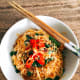Place the noodles in a bowl. Garnish with thinly sliced peppers and fried shallots. Serve immediately.
