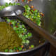 Step four: Add ground paste. Continue to saute over low fire until the excess moisture evaporates from the paste.