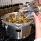 Pour into your pressure canner the recommended amount of water (usually 2 quarts), and begin heating it.