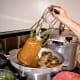 Lift each jar out carefully with a jar lifter. If you have waited for the canner to cool sufficiently, you should be able to remove the jars promptly.