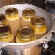 The usual canner holds 7 quart jars - 6 around the outside, and 1 in the center. We had only six full jars for this load. Note the wire rack in the bottom of the canner, which holds the jars off the bottom.