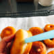 Using a drinking straw, pierce a small hole in the side of each doughnut.