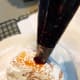 Fill a piping bag or resealable plastic bag with the corner snipped off with jam. Squeeze a small bit of jam into each donut.