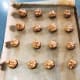 Place the balls a couple of inches apart on the prepared baking sheets.