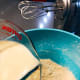 Slowly pour the mixture into the mixing bowl.