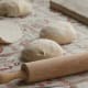 roll out each piece of dough onto floured surface