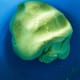 In a large bowl, combine the glutinous rice flour with the pandan juice. Use your hand to knead the mixture lightly until it is smooth.