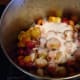 Add sugar to taste. 1/3 to 1/2 the volume of plums is average. Add any spices you wish along with the sugar, and stir thoroughly, mushing the plums with a wooden spoon. Use lid as required to build heat.