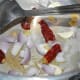 Step one: Heat butter or olive oil in a pressure cooker. Saute onions, ginger, garlic, and broken dry red chilies until the onions turn golden.