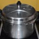 Step three: Cover the cooker and place the weight. Cook up to 4 whistles and simmer for 2 minutes. Turn off the heat.