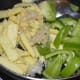 Step two: Throw in the parboiled baby corn, capsicum, and ginger-garlic paste. Add some salt. Mix well. Saute the mixture until you get a nice aroma.