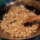 Frying the meat mixture with mushrooms and dongcai.