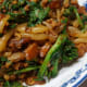 Rice Drops in Dongcai Mushroom Pork sauce. Italian rape as green leafy vegetable.