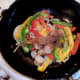 Chopped sausages and five spice are added to the wok