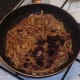 Sun dried tomatoes are added to softened onion