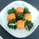 Plated spicy kale around sweet potato and carrot mash