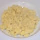 Mashed potatoes are arranged as a bed on the serving plate