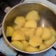 Drained potatoes are left to steam off before they are mashed