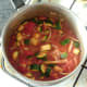 Vegetables in spicy tomato sauce are brought to a simmer
