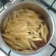 Cooked pasta is added to heated beans