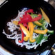Stir frying onion and peppers