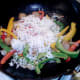 Cooled rice is added to sausages and peppers