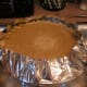 Place the filled pie pan onto a foil-lined cookie sheet to keep the oven clean.