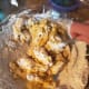 Slowly mix dry ingredients into the shortening, egg, vanilla extract mixture until it starts to clump. Set fork aside and knead the clumps with your hands into dough.
