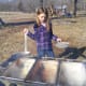 Pouring sap through the strainer to remove debris.