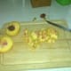 Peaches are chopped and the pits are removed.
