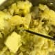 Mash the potatoes. Add milk, butter, and garlic, and continue mashing.