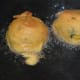 Fry 2 to 3 balls at a time. Don't overcrowd them! Turn them occasionally to ensure uniform frying. Reduce the heat once they become crispy. Fry them until they become golden brown.