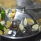 Step 2: Add chopped ginger, garlic cloves, and green chilies to a mixer or blender. Pulse 2 to 3 times to get a paste.