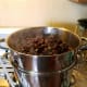Grapes in the top pan are starting to release their juice.