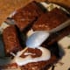 Drizzle marshmallow topping over brownies.