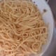 Drain the pasta and transfer to a large bowl.