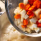 Add the potatoes and carrots into the pot.