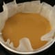 (Step 4) The caramel sauce in the bottom of the cake tin.